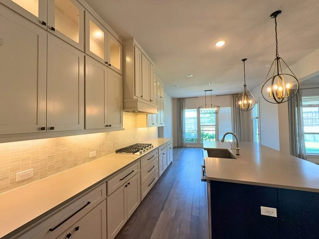Kitchen with gas cooktop and decorative lighting