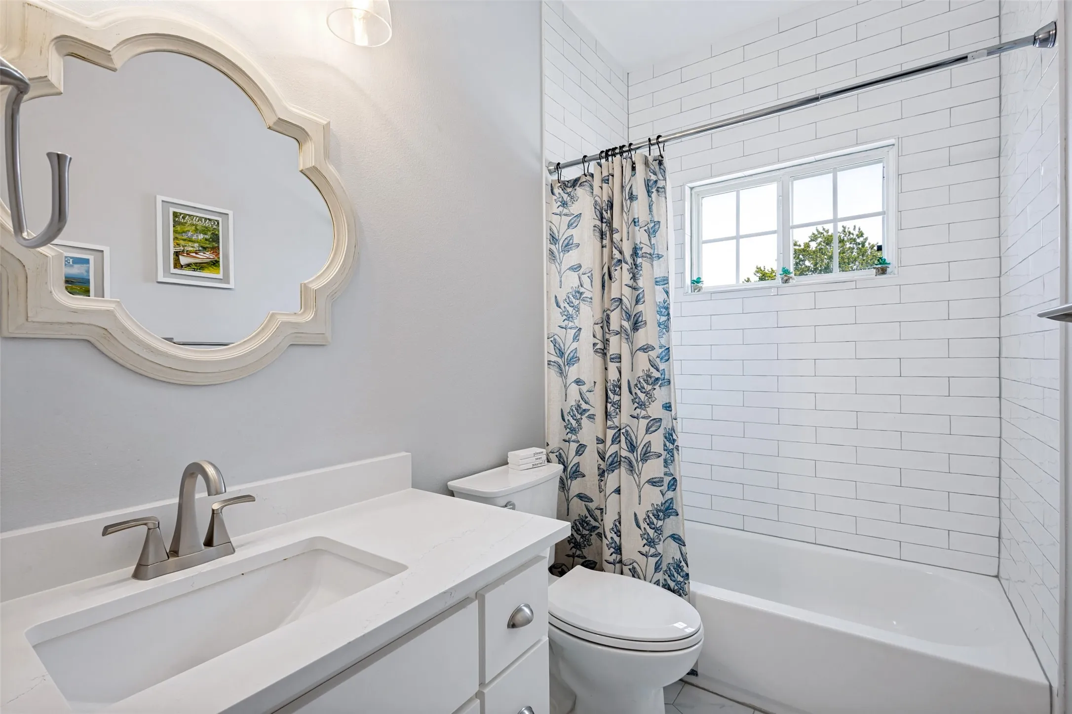 White subway tile shower surround with an integrated bathtub