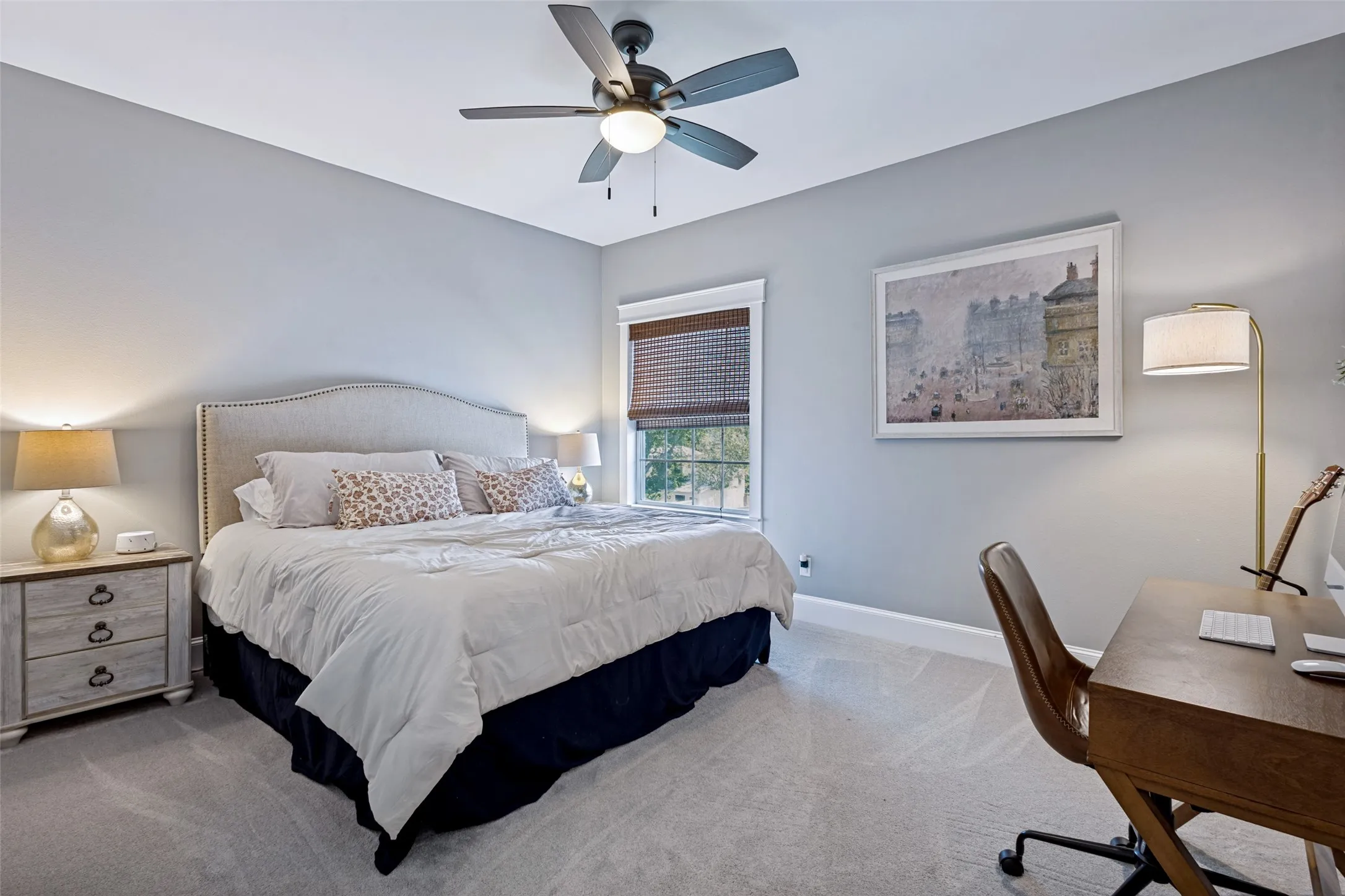Recessed window with wood-finish blinds, light gray wall paint, gray carpet flooring, and a ceiling fan with integrated lighting