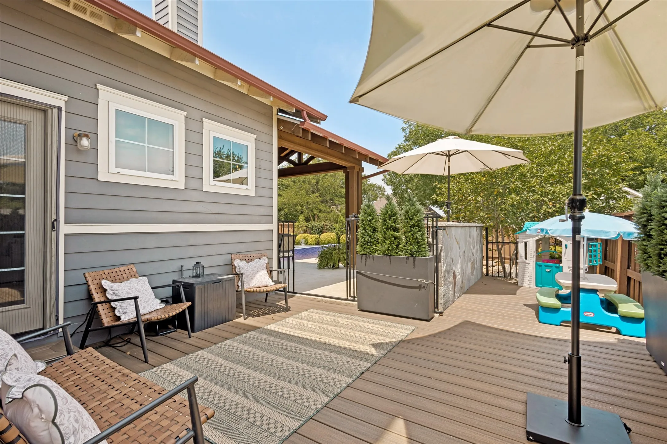 Composite deck with a gray-sided exterior and white trim windows