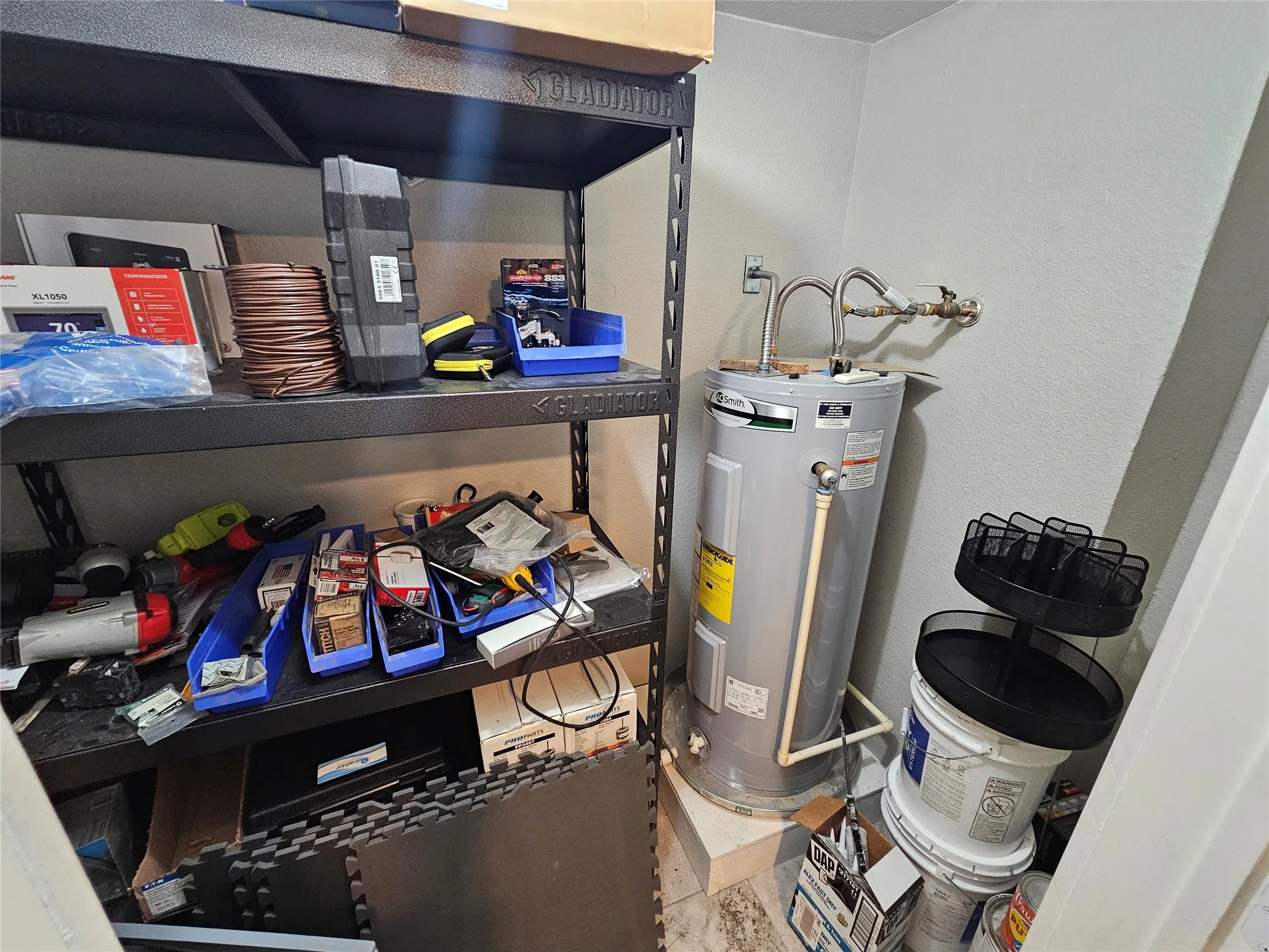 Water heater installation with visible plumbing connections