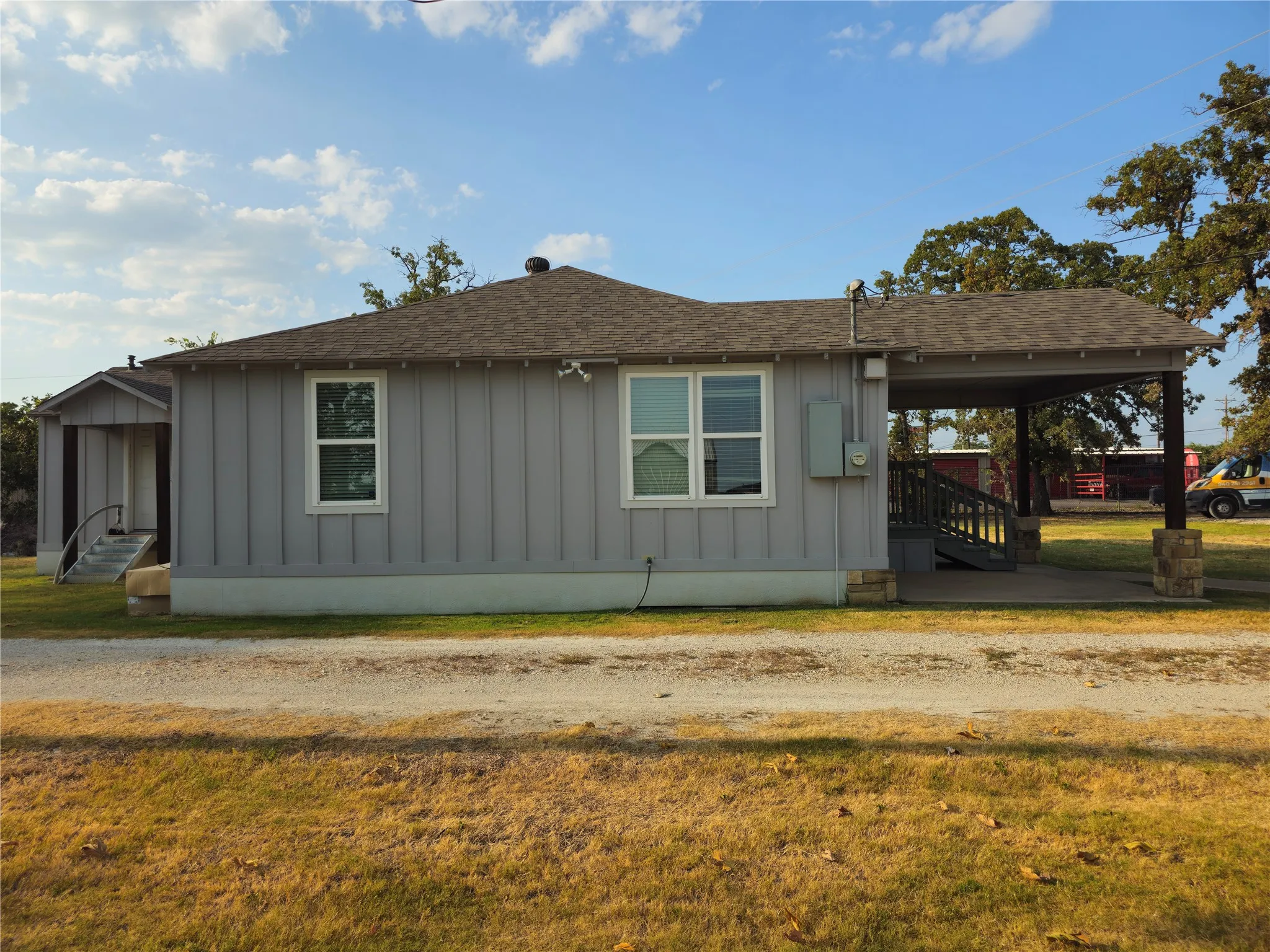 Side of office by gravel road