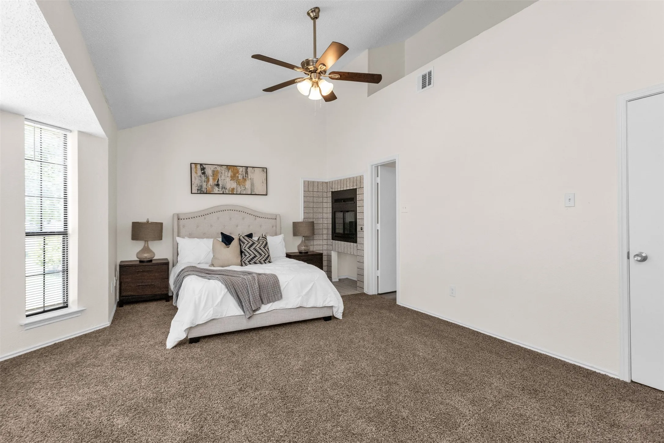 Fireplace between primary bedroom and bathroom