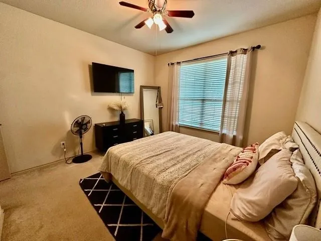 Bedroom featuring carpet flooring and a ceiling fan