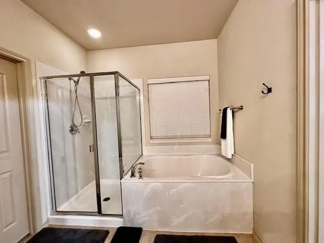 Bathroom with a garden tub and a shower stall
