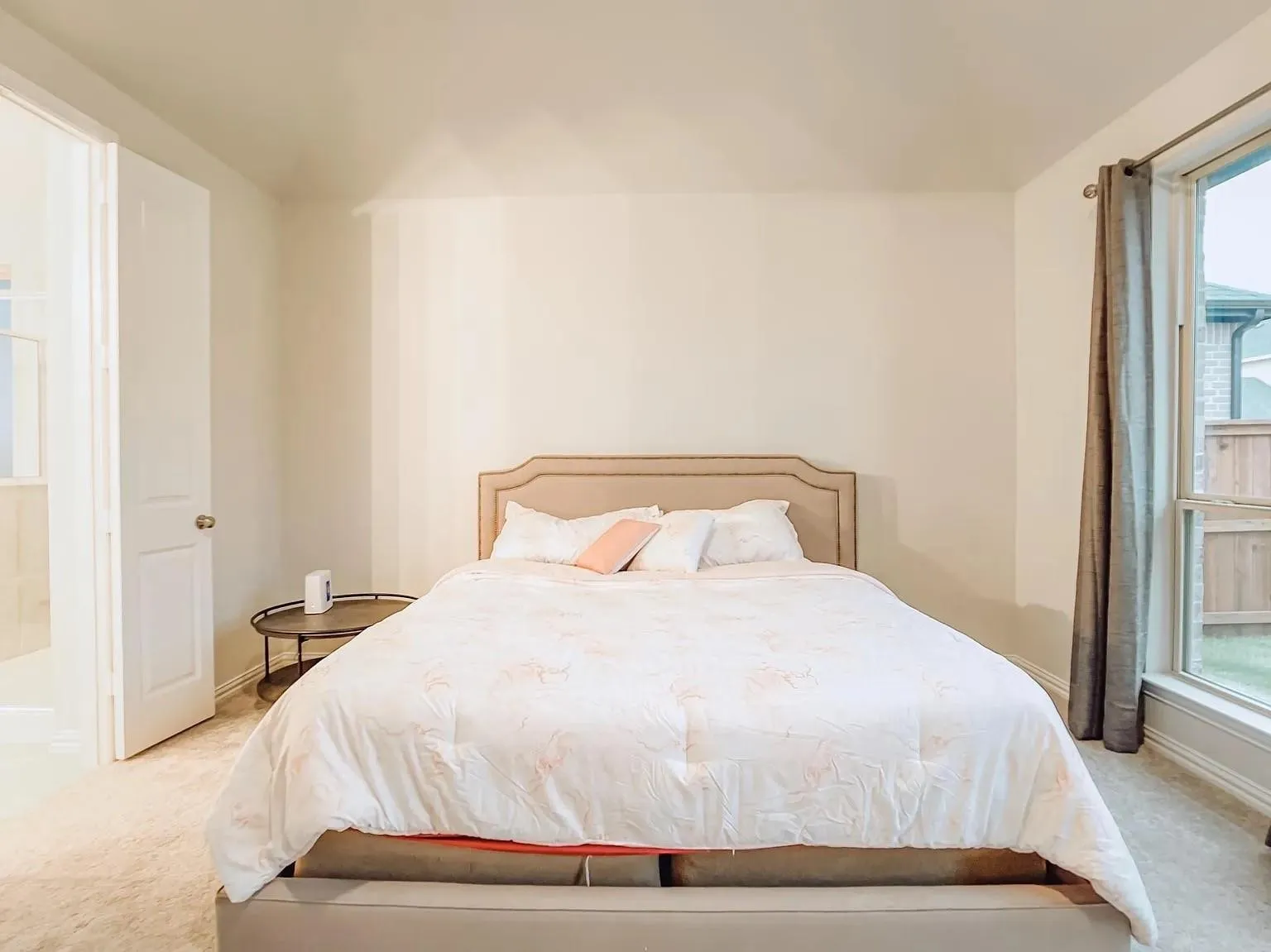 Cream-toned walls with carpeted flooring