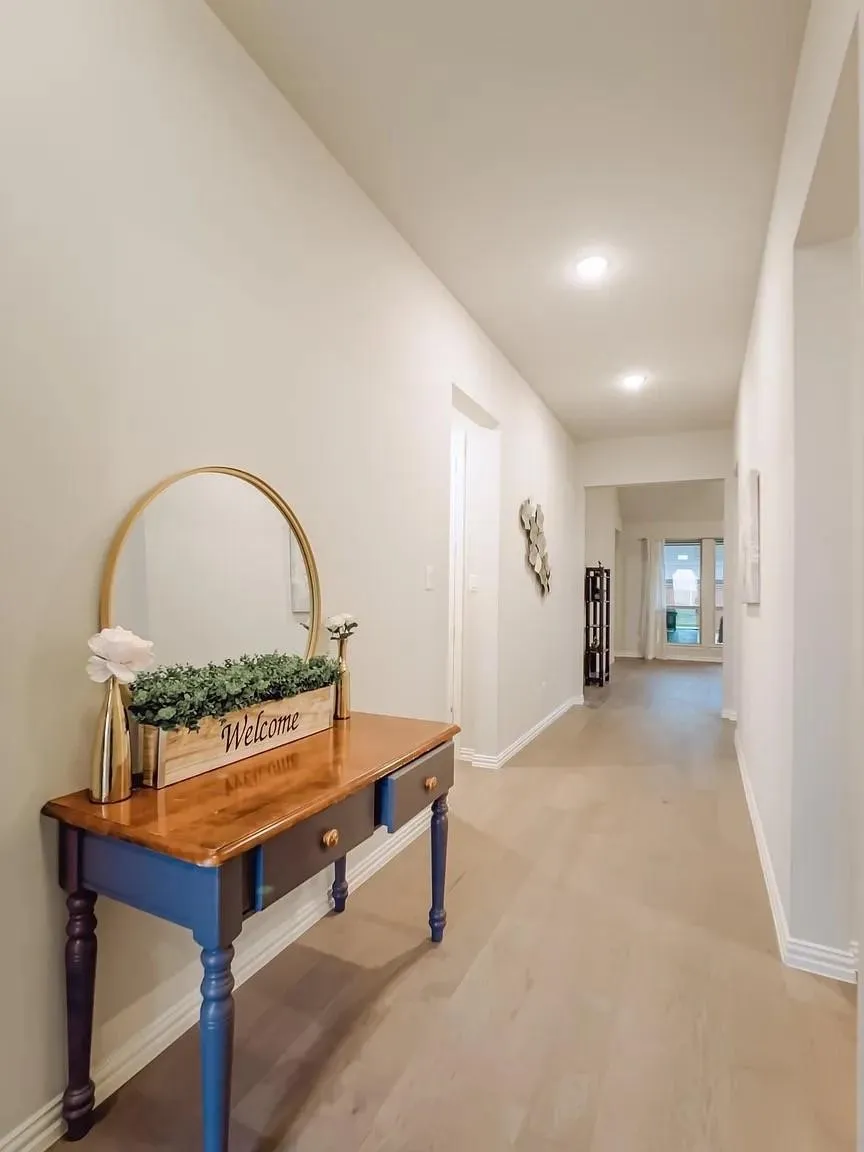 Recessed ceiling lighting, light wood-finish flooring, and white wall finishes