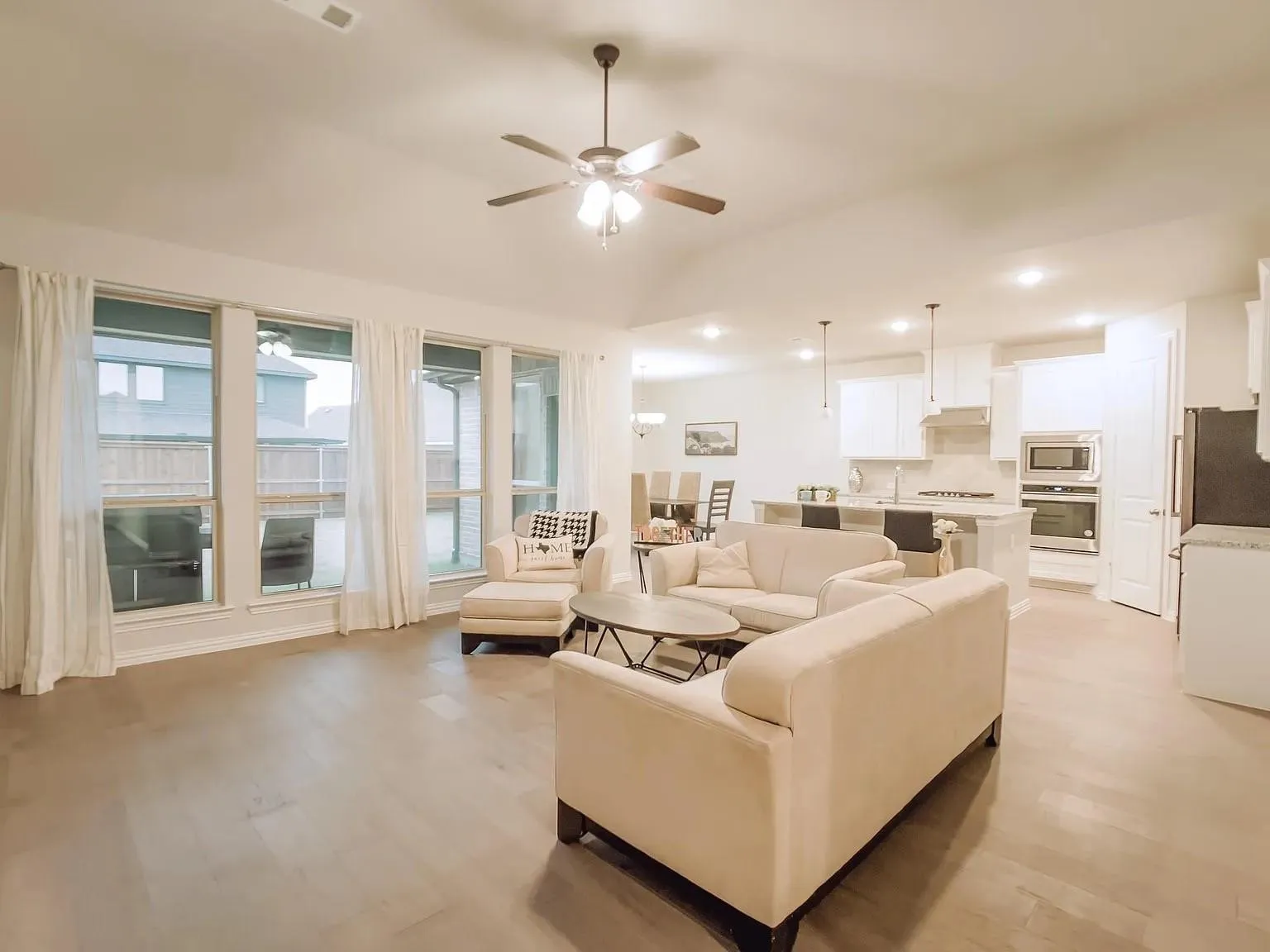 Spacious interior with wood-finish flooring, recessed lighting, and a ceiling fan