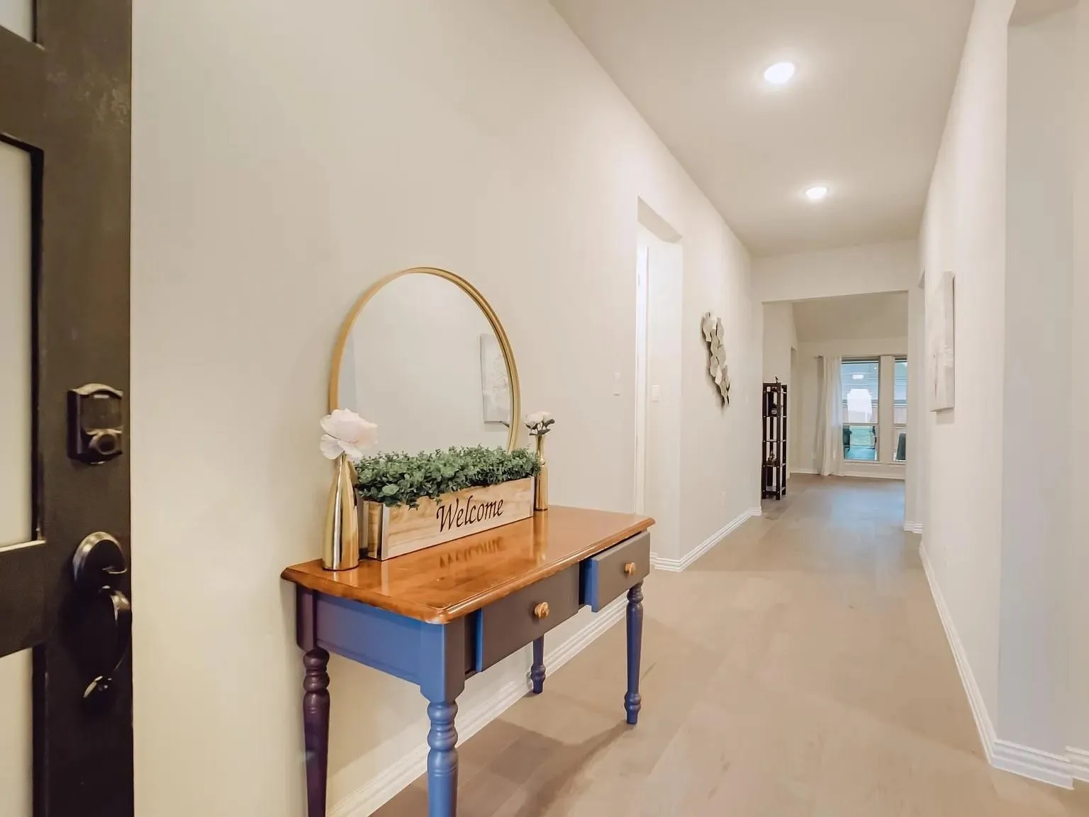 Recessed lighting, light-toned wood-finish flooring, white wall paint, and white trim