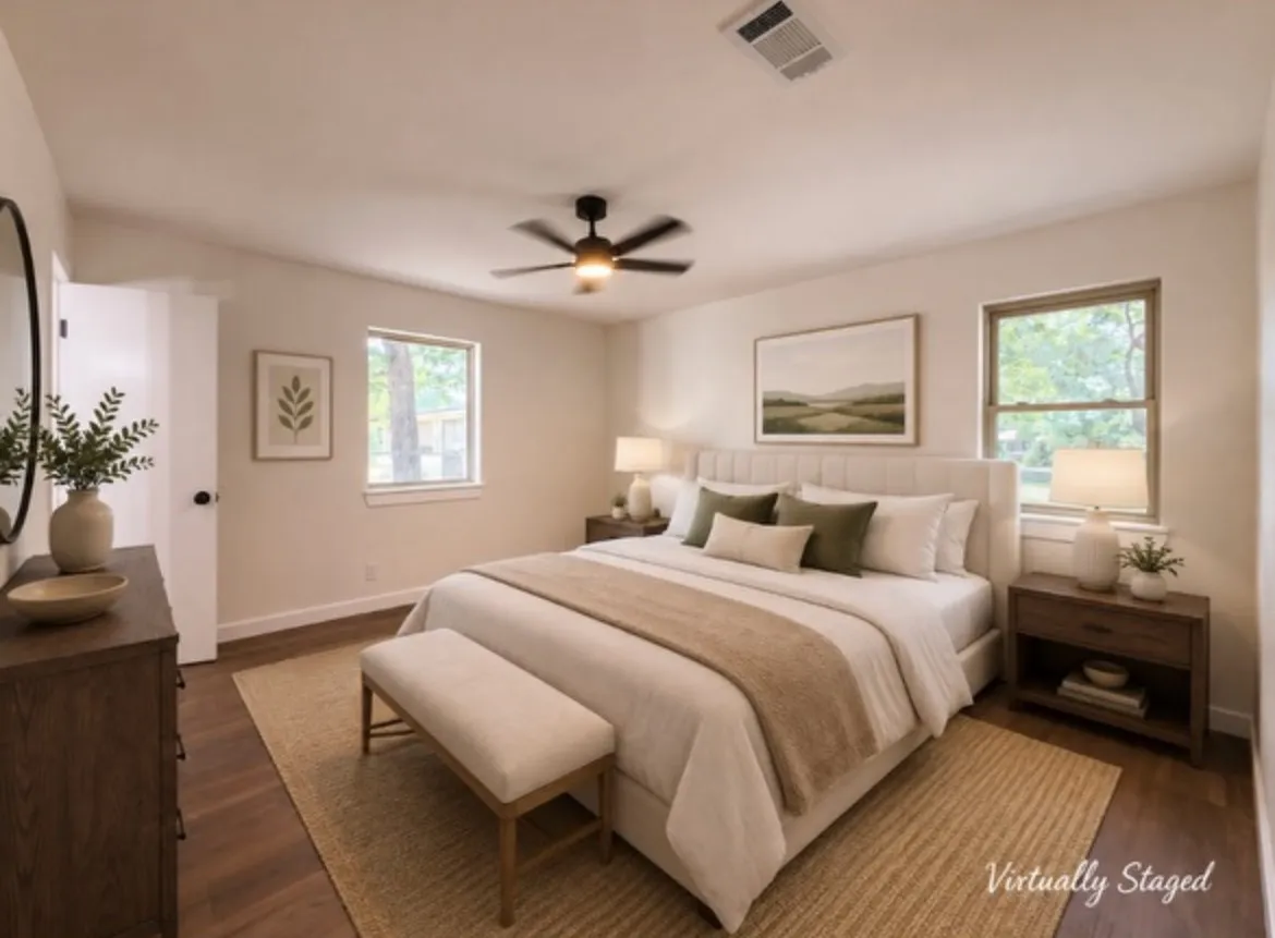 Bedroom featuring wood-finish flooring, two windows with white trim, and a ceiling fan with integrated lighting