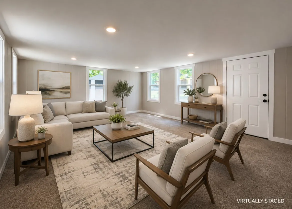 Spacious living area featuring neutral carpeting, recessed lighting, white trim, and multiple windows providing natural light