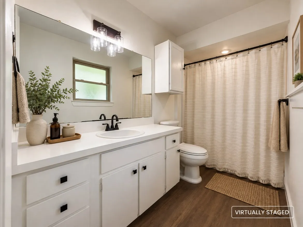 Bathroom with white vanity, integrated sink, and matte black faucet