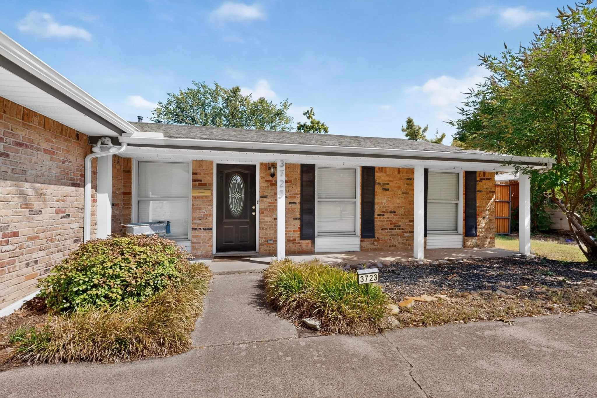Brick exterior with a covered porch