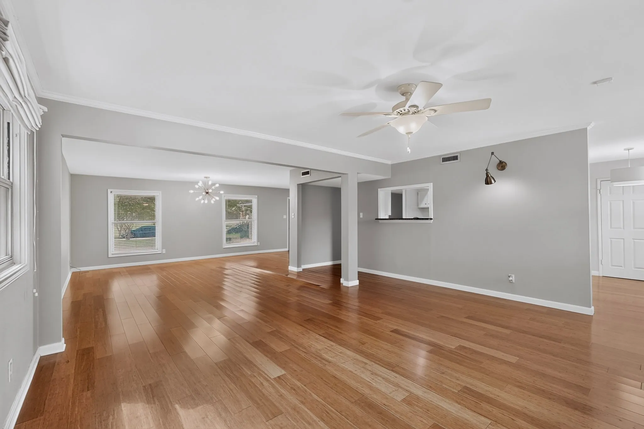 Open-concept living space featuring wood-finish flooring, recessed lighting, and a ceiling fan