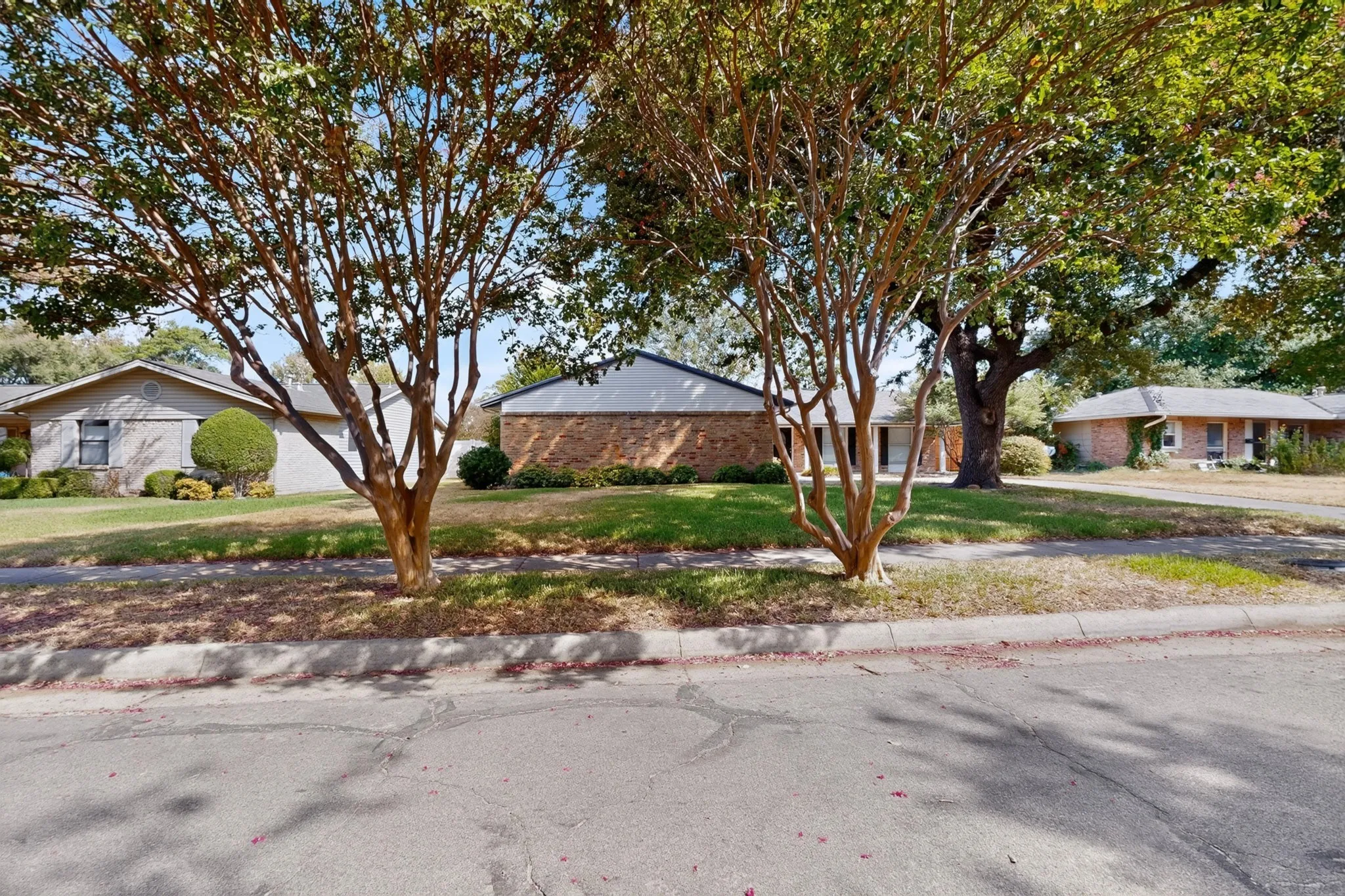 Brick exterior with an attached garage and a concrete driveway