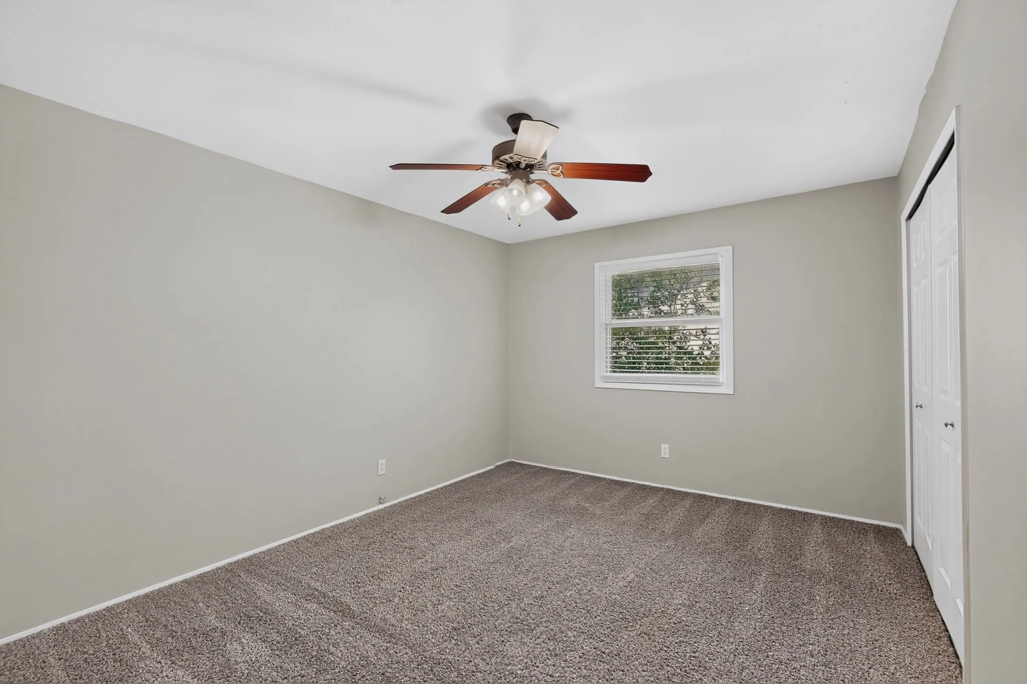Neutral-toned walls complement plush carpeting