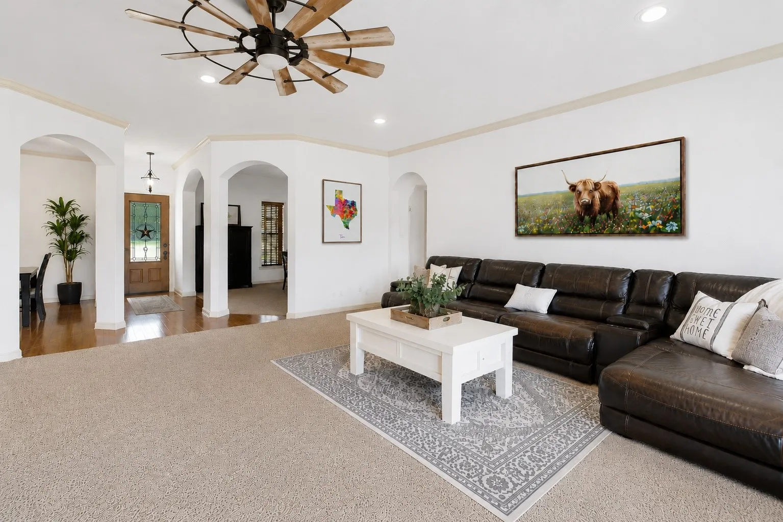 With generous space to gather, soft carpeting, crown molding, and recessed lighting, the family room opens through graceful archways to the entry, office, and formal dining room, keeping the home’s main living spaces comfortably connected.