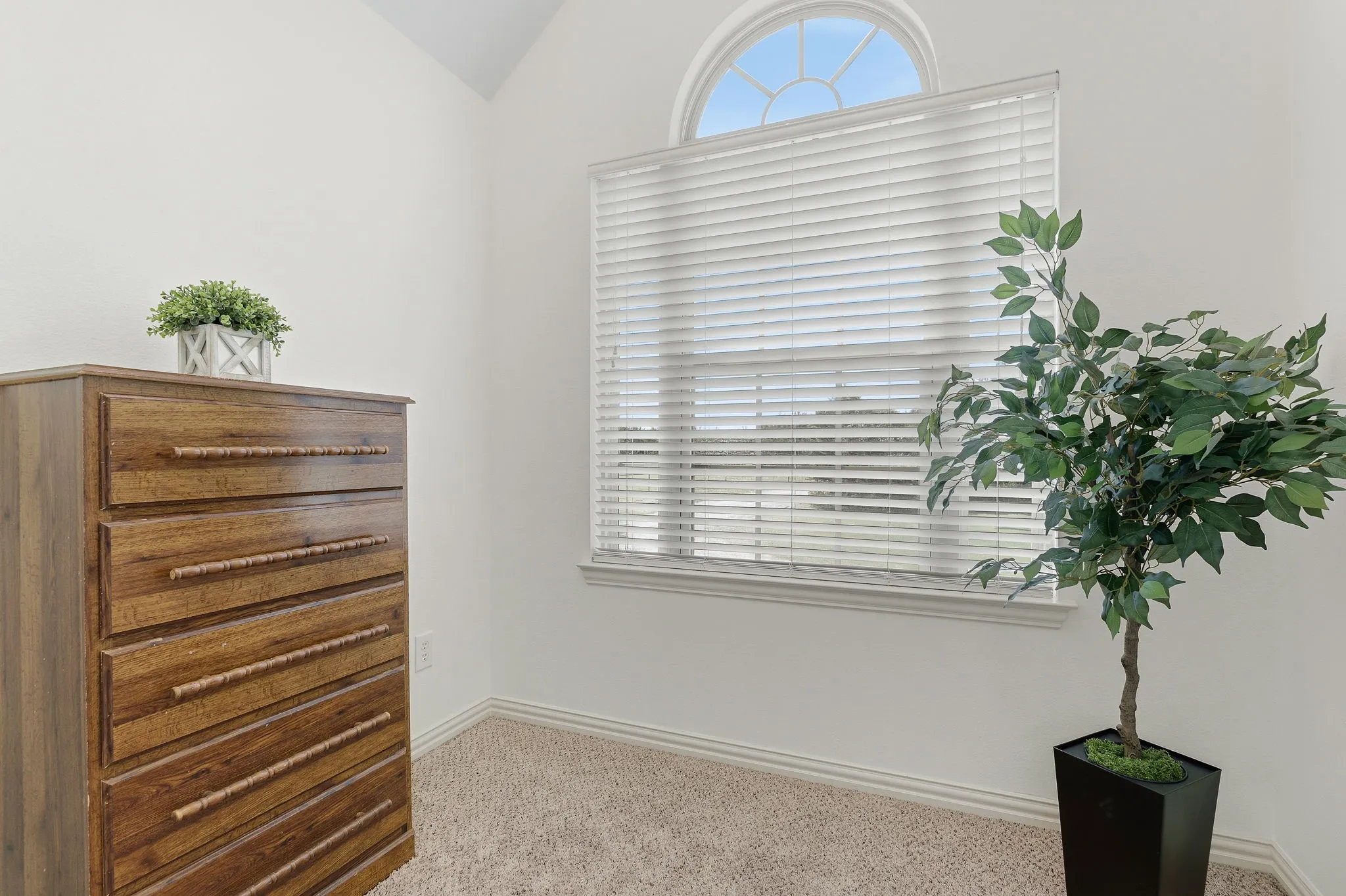 Tucked between the two upstairs bedrooms just off the Jack and Jill bath, this cozy bonus nook offers an inviting spot to study or settle in with a favorite book. A beautiful arched window welcomes natural light, while soft carpeting adds comfort to this versatile little retreat.
