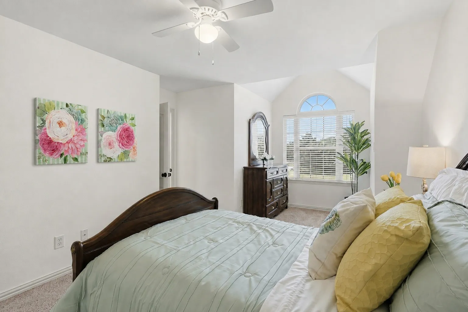 A charming arched window and softly angled ceiling add character to this inviting upstairs bedroom, where natural light and relaxing tree views create a peaceful retreat. A shared Jack and Jill bath connects the two bedrooms, while a cozy bonus space between them offers the perfect spot for a study nook or quiet reading area.