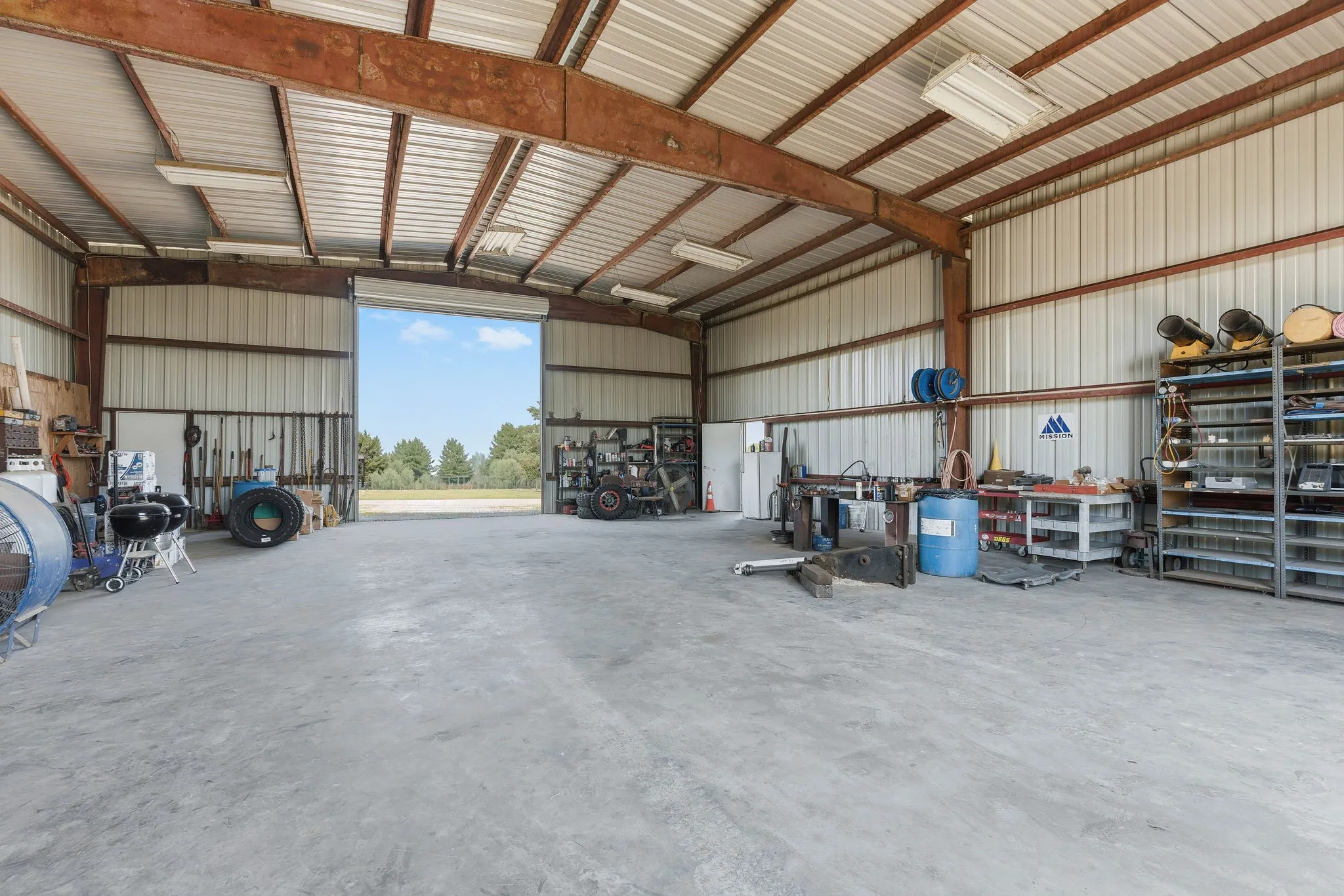 The impressive 40-by-50-foot workshop features 16-foot walls, steel framing, and a concrete floor, offering generous space for hands-on projects, equipment storage, and your favorite hobbies.