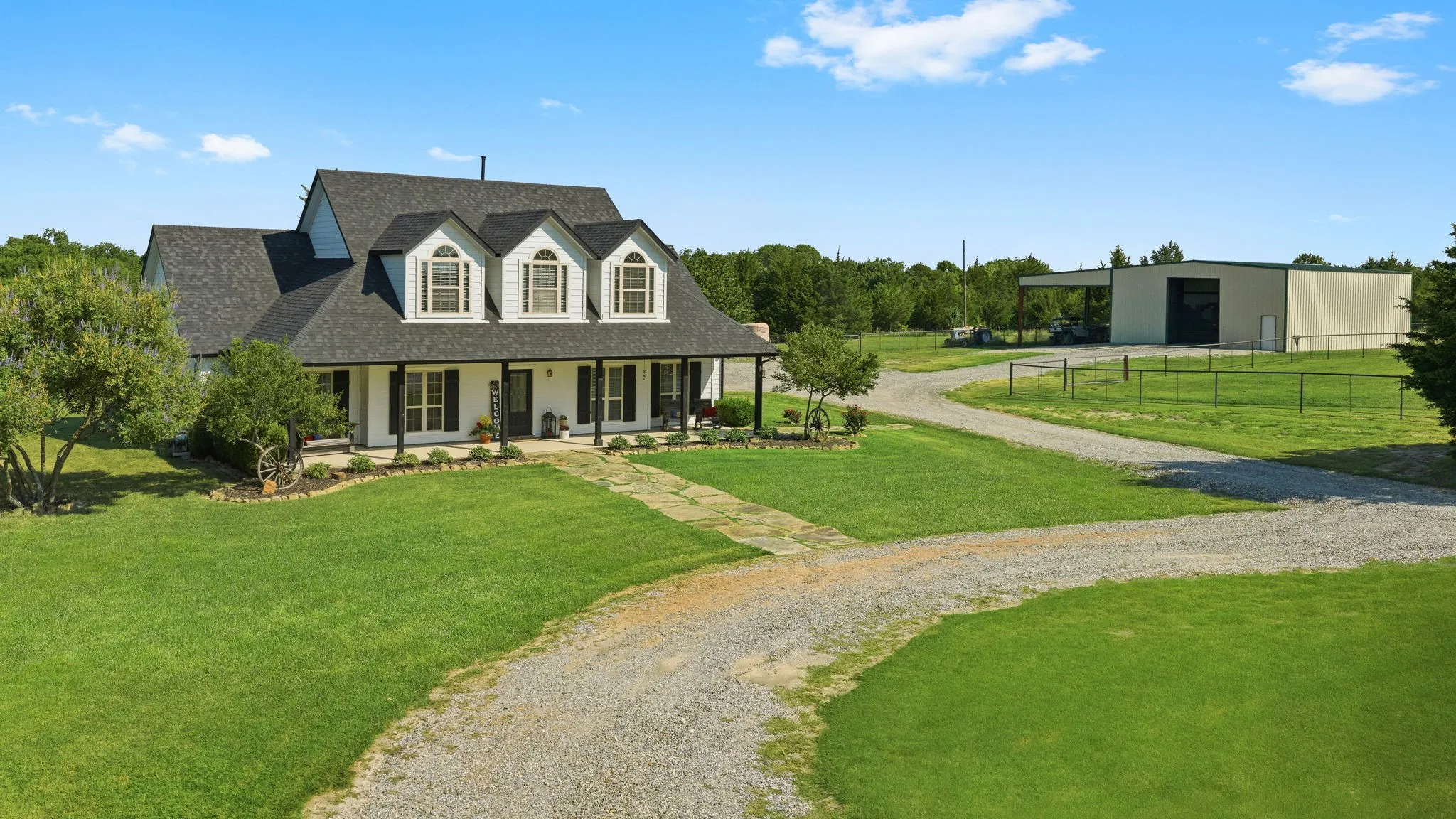 welcoming farmhouse and substantial workshop share this scenic 10.4-acre setting, with a curving gravel drive, mature trees, and fenced grounds offering room to relax, pursue hobbies, and enjoy country living.