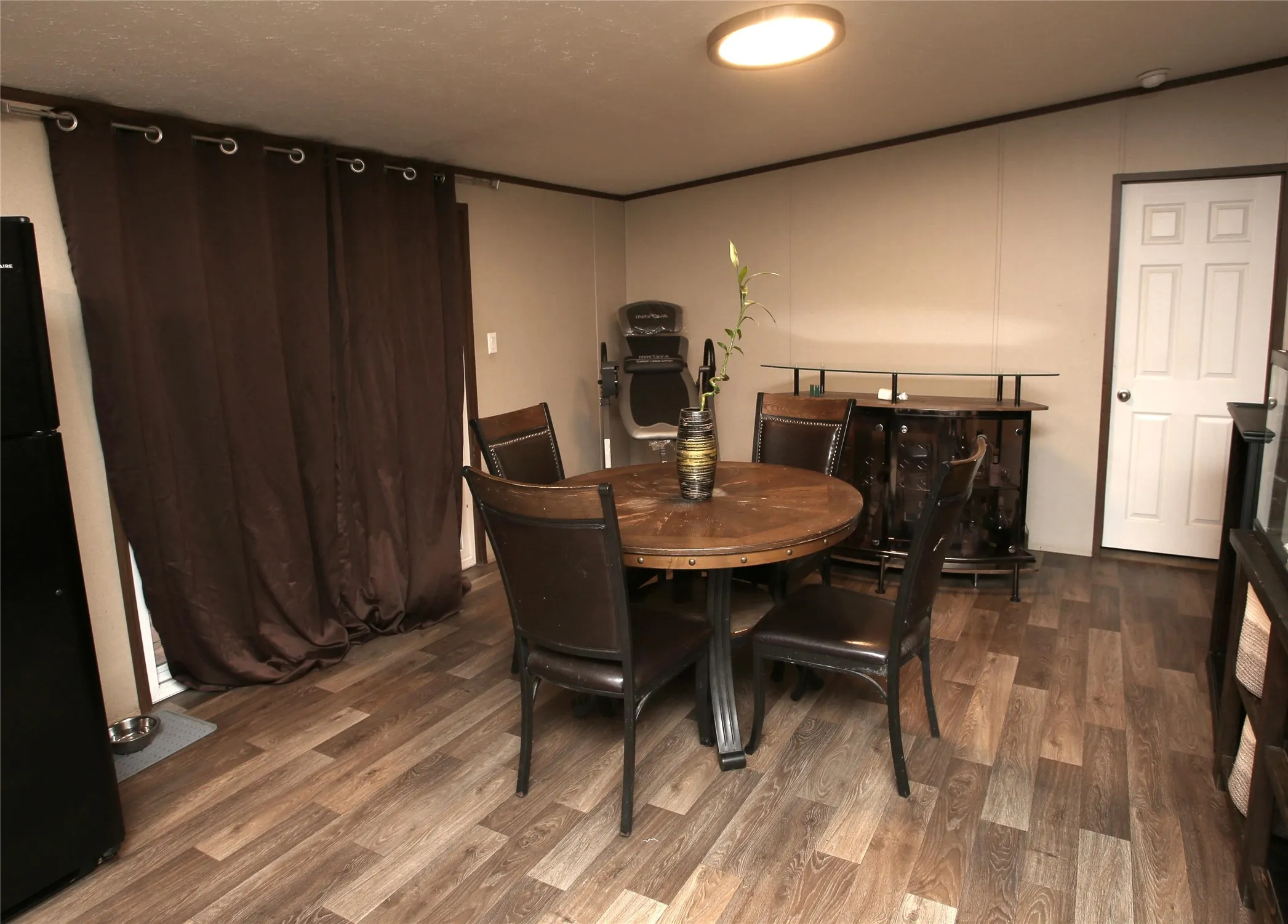 Dining room off sliding glass doors leading to a backyard deck.