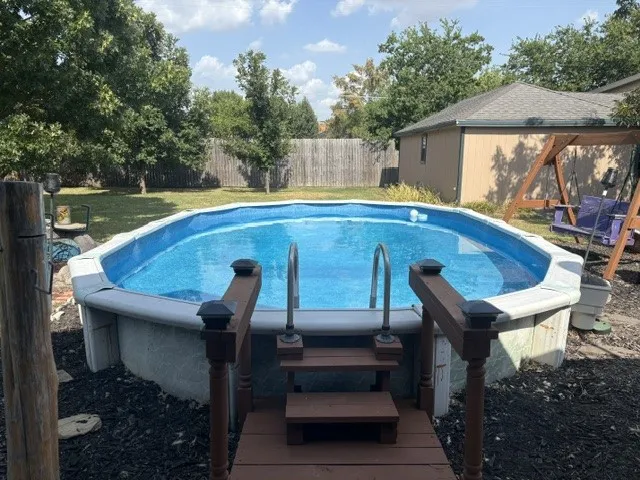 Above-ground pool with wood-finish decking and steps