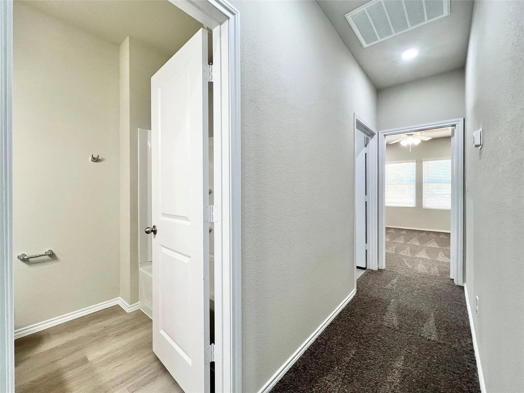 Hallway to laundry room and primary suite