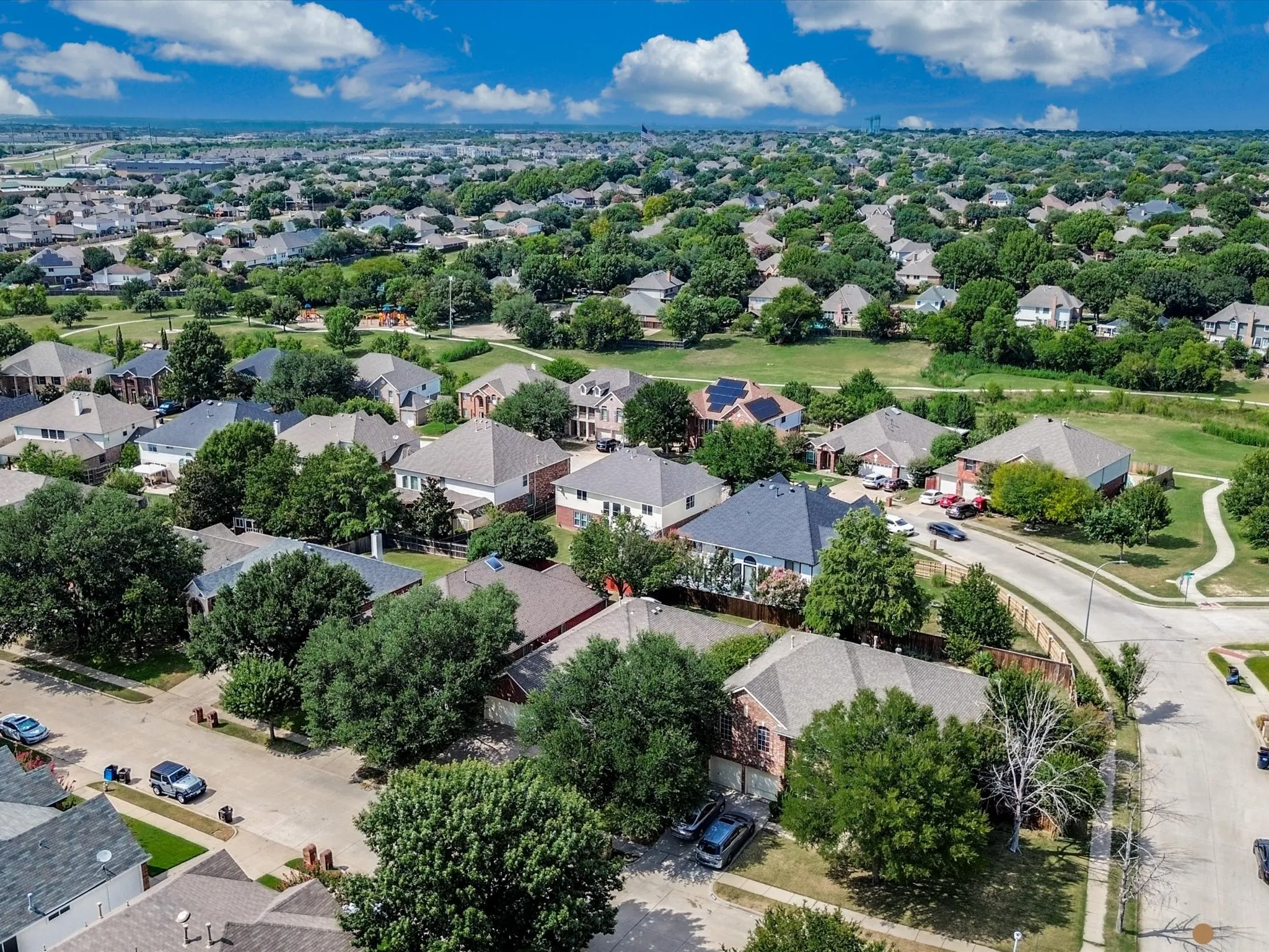 Expansive residential neighborhood featuring numerous mature trees and paved streets