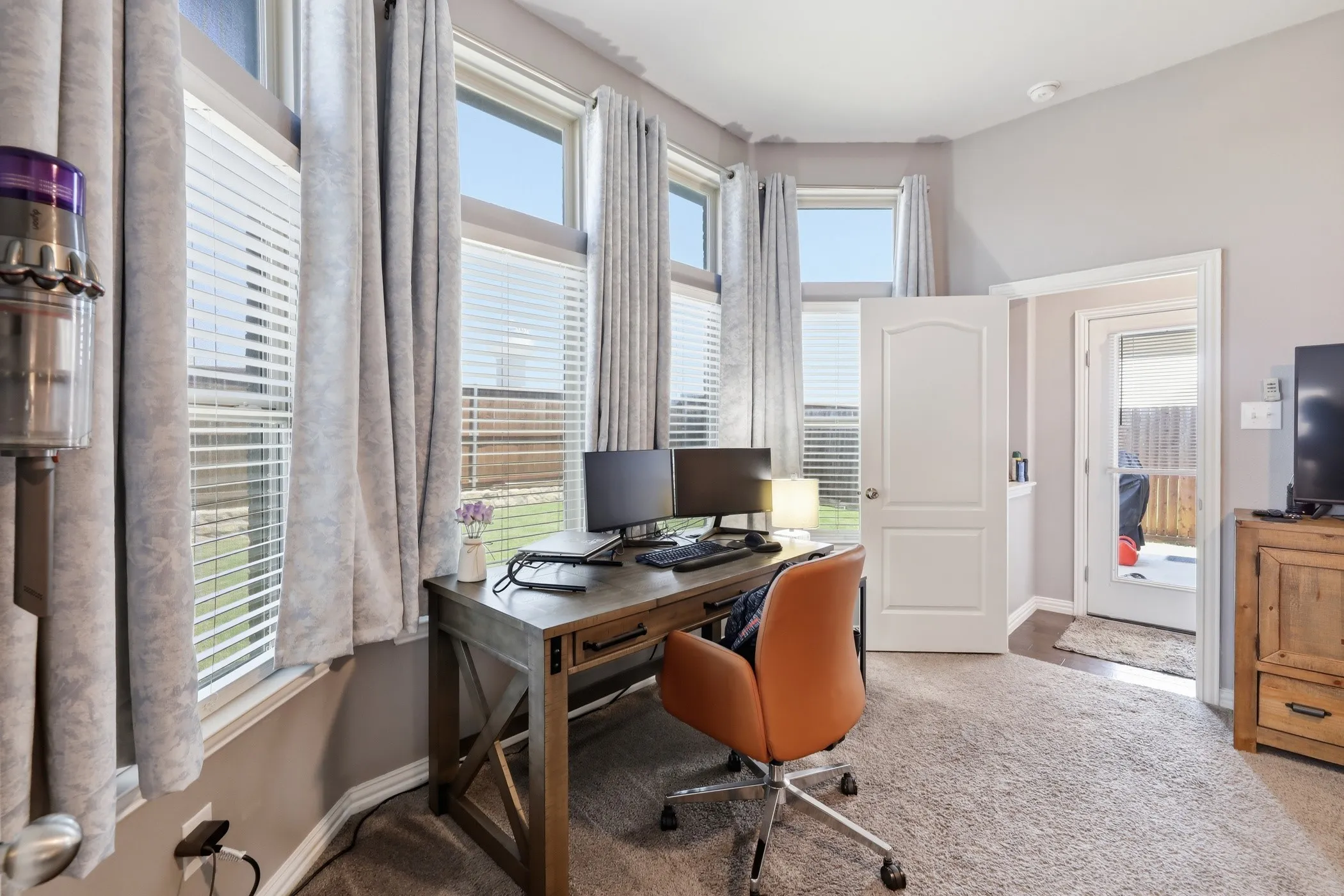 Primary bedroom is large enough to have a small office area set up on the recessed window area