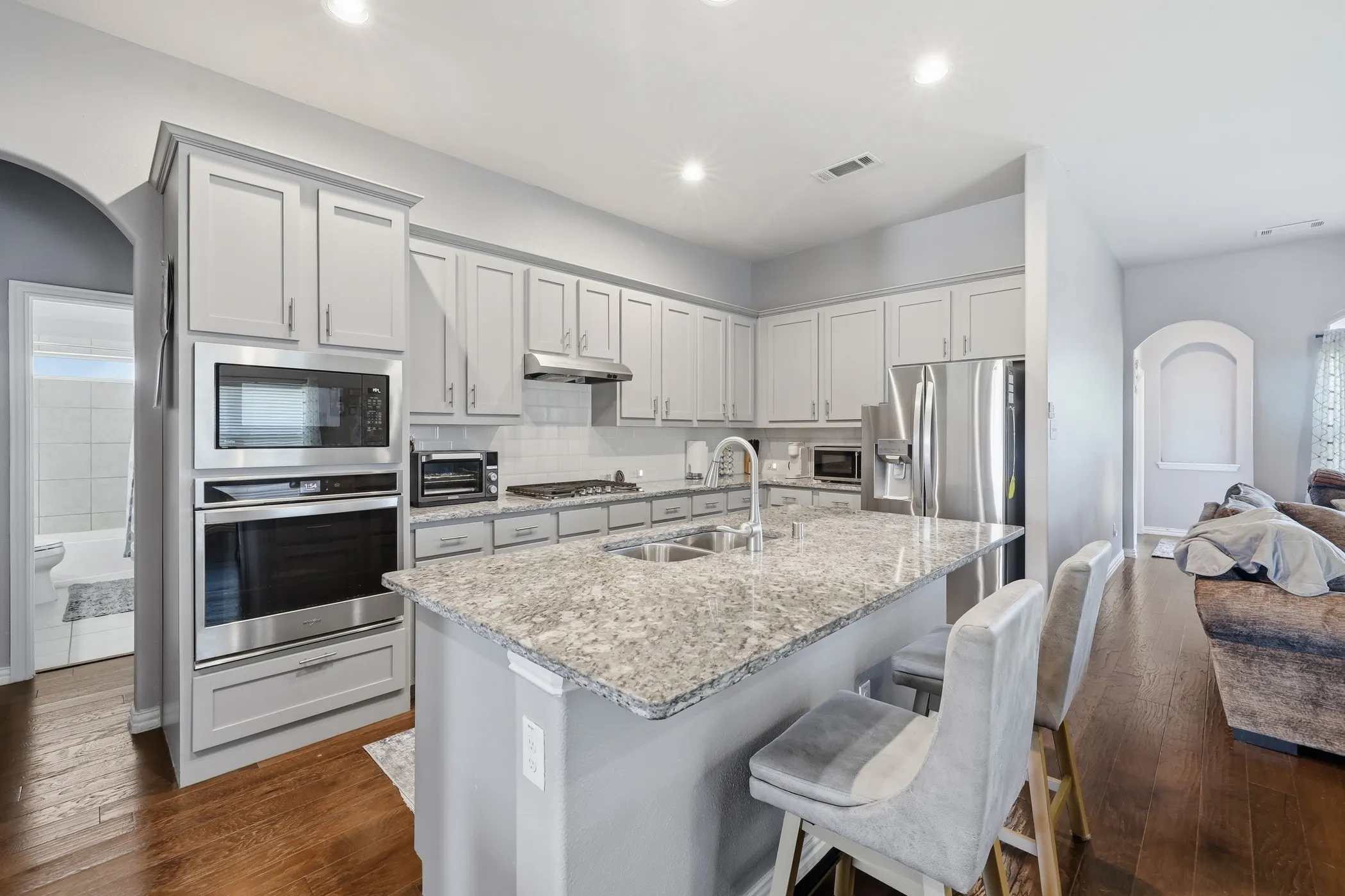 Kitchen featuring light gray cabinetry, stainless steel appliances, and large island