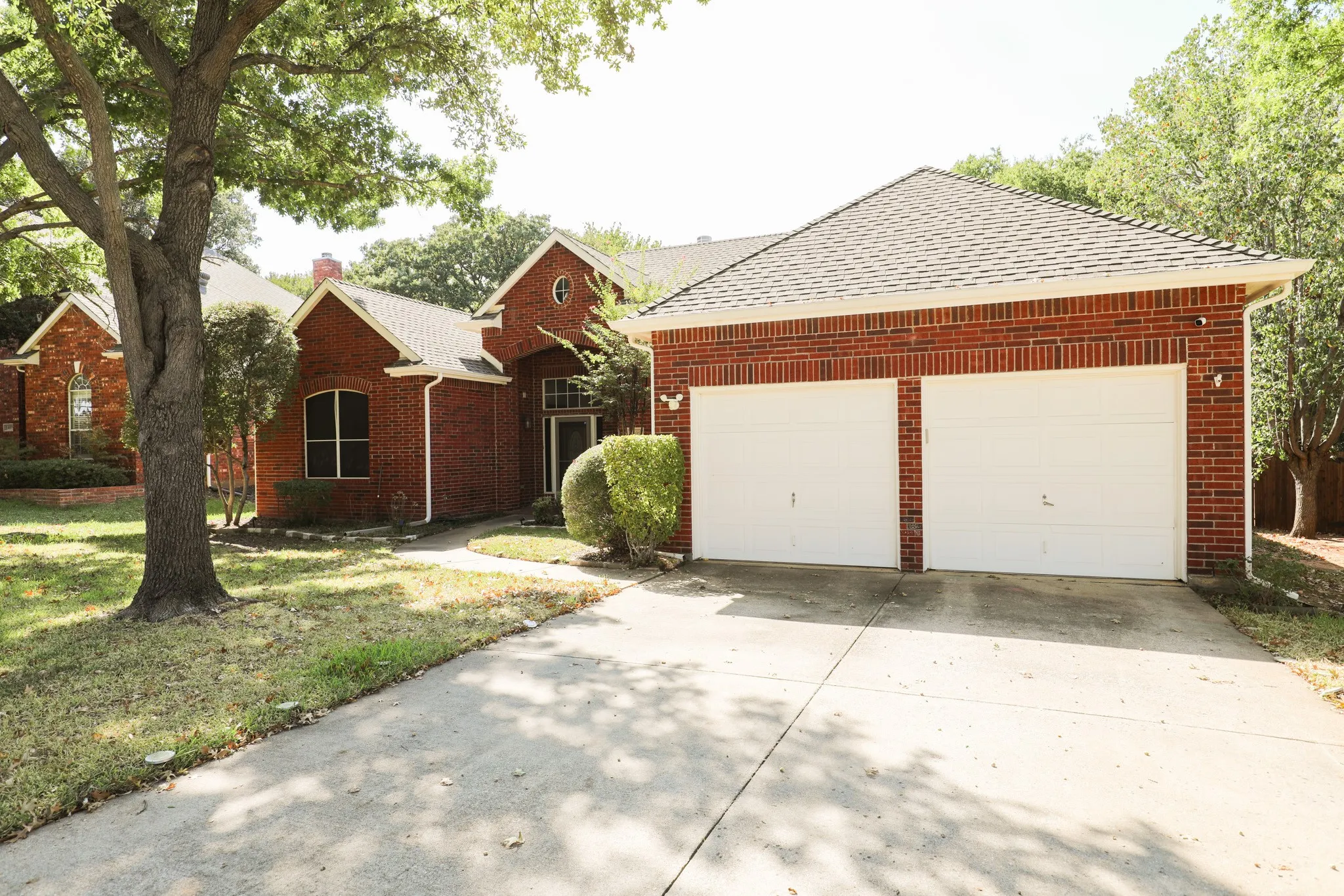 Brick exterior with a gabled roof and a two-car garage