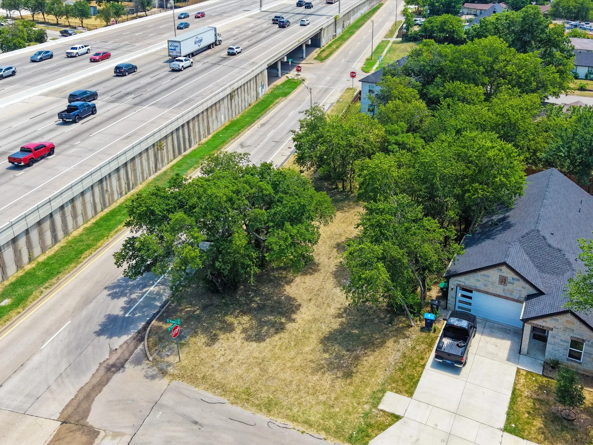 Charming residential property featuring a spacious lot with mature shade trees and established landscaping