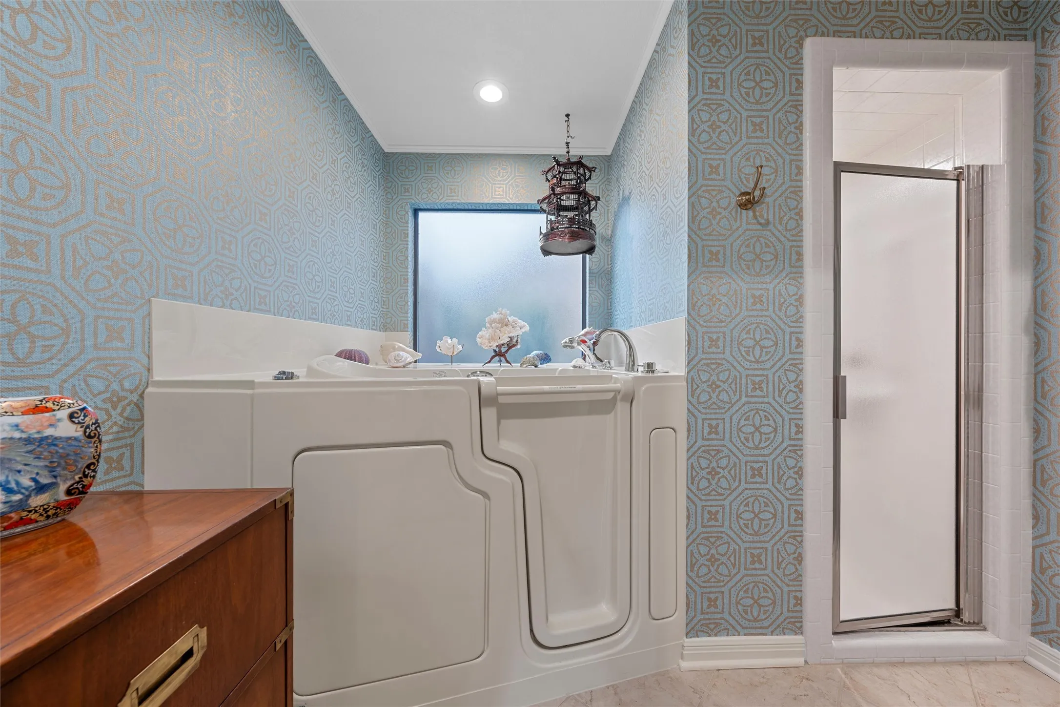 Walk-in bathtub featuring chrome fixtures and a frosted window