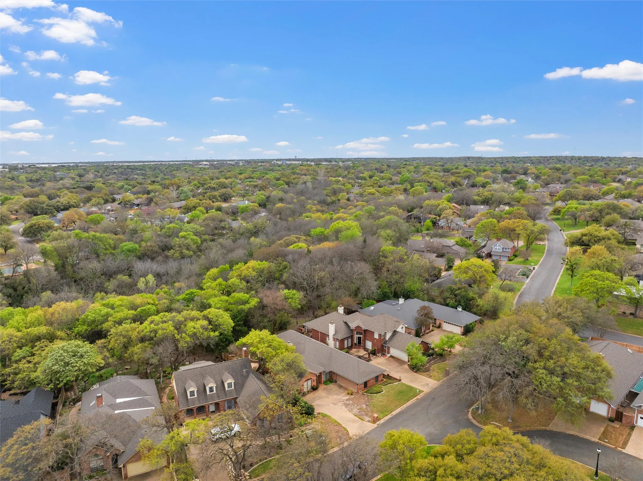 Residential neighborhood featuring mature trees and winding streets
