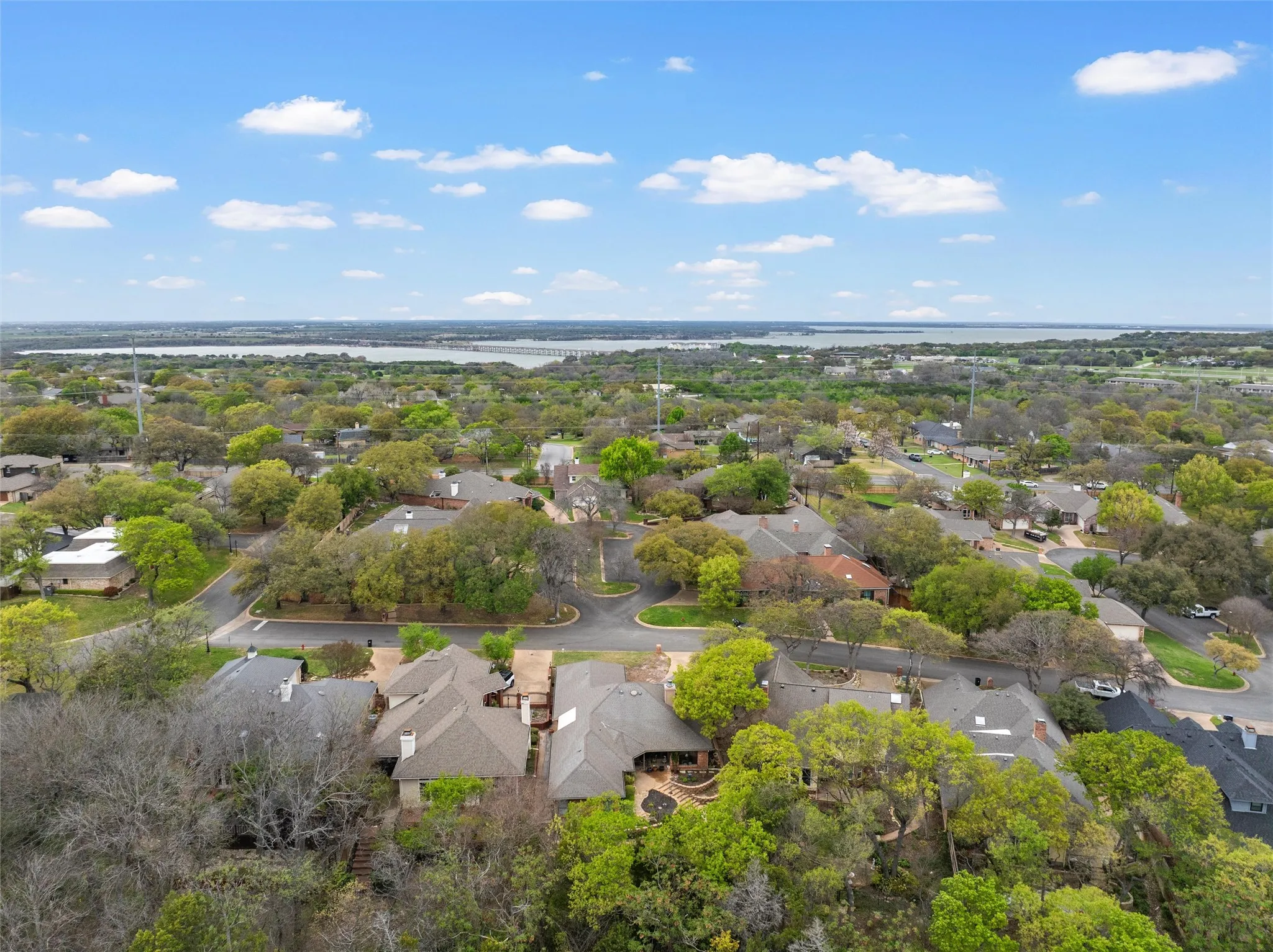 Expansive neighborhood featuring mature trees and a distant body of water