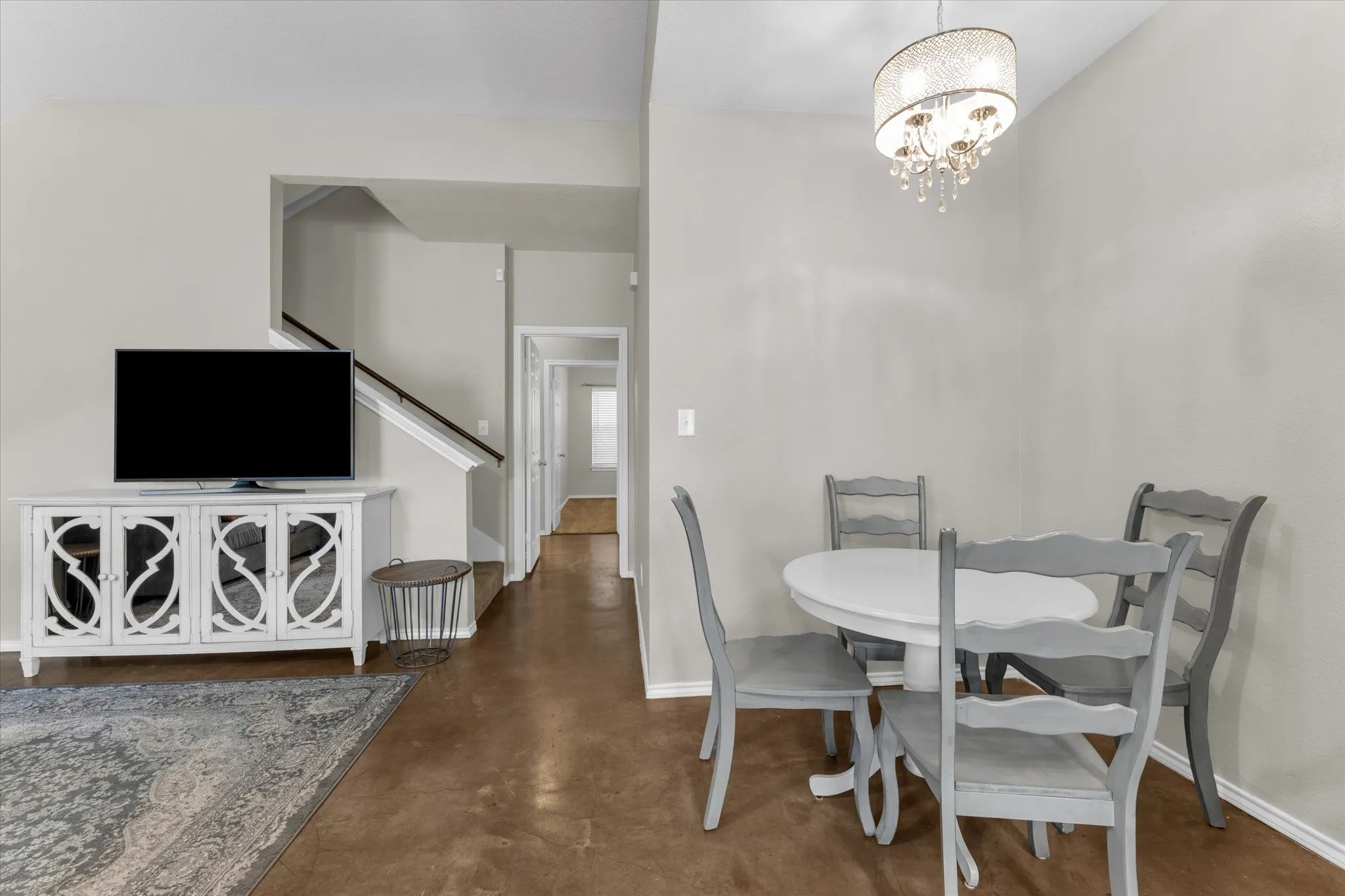 Open-concept living space featuring wood-finish flooring and light neutral wall tones