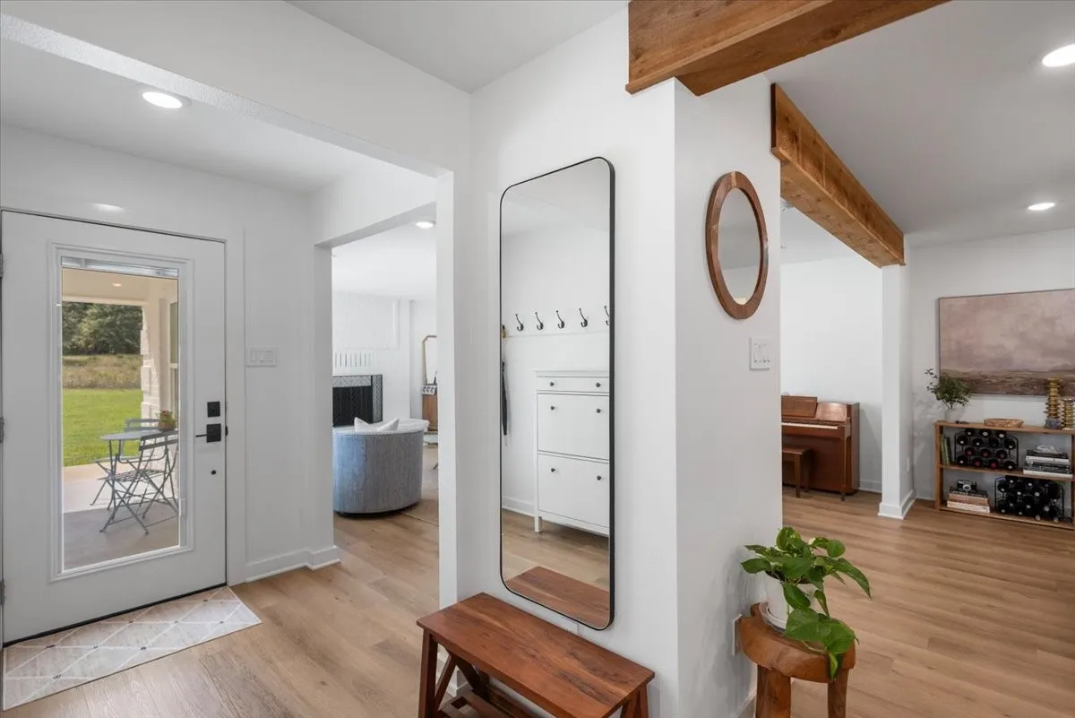 Open concept entry foyer featuring light wood-finish flooring and recessed lighting