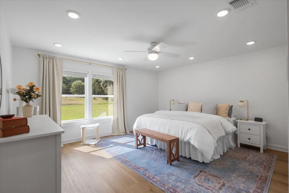 Spacious Primary En Suite featuring light wood-finish flooring, recessed ceiling lights, and a ceiling fan
