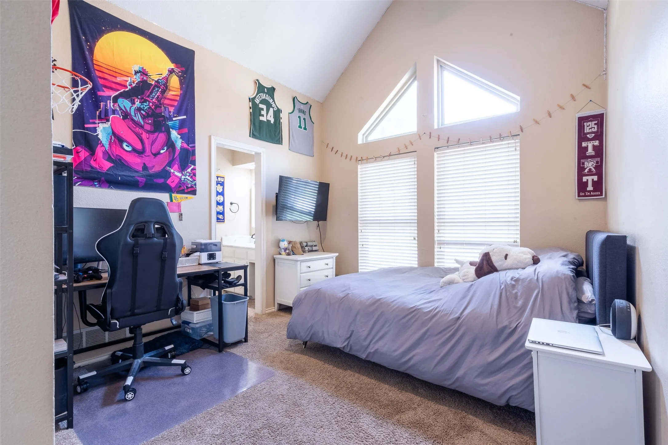 Vaulted ceiling room featuring carpet flooring and a neutral color palette