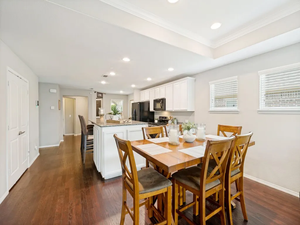 Open-concept living area featuring rich wood-finish flooring