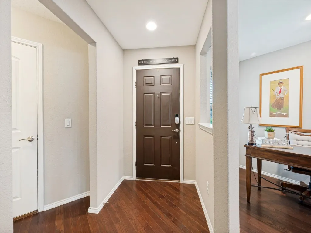 Entryway featuring rich wood-finish flooring and  a paneled entry door