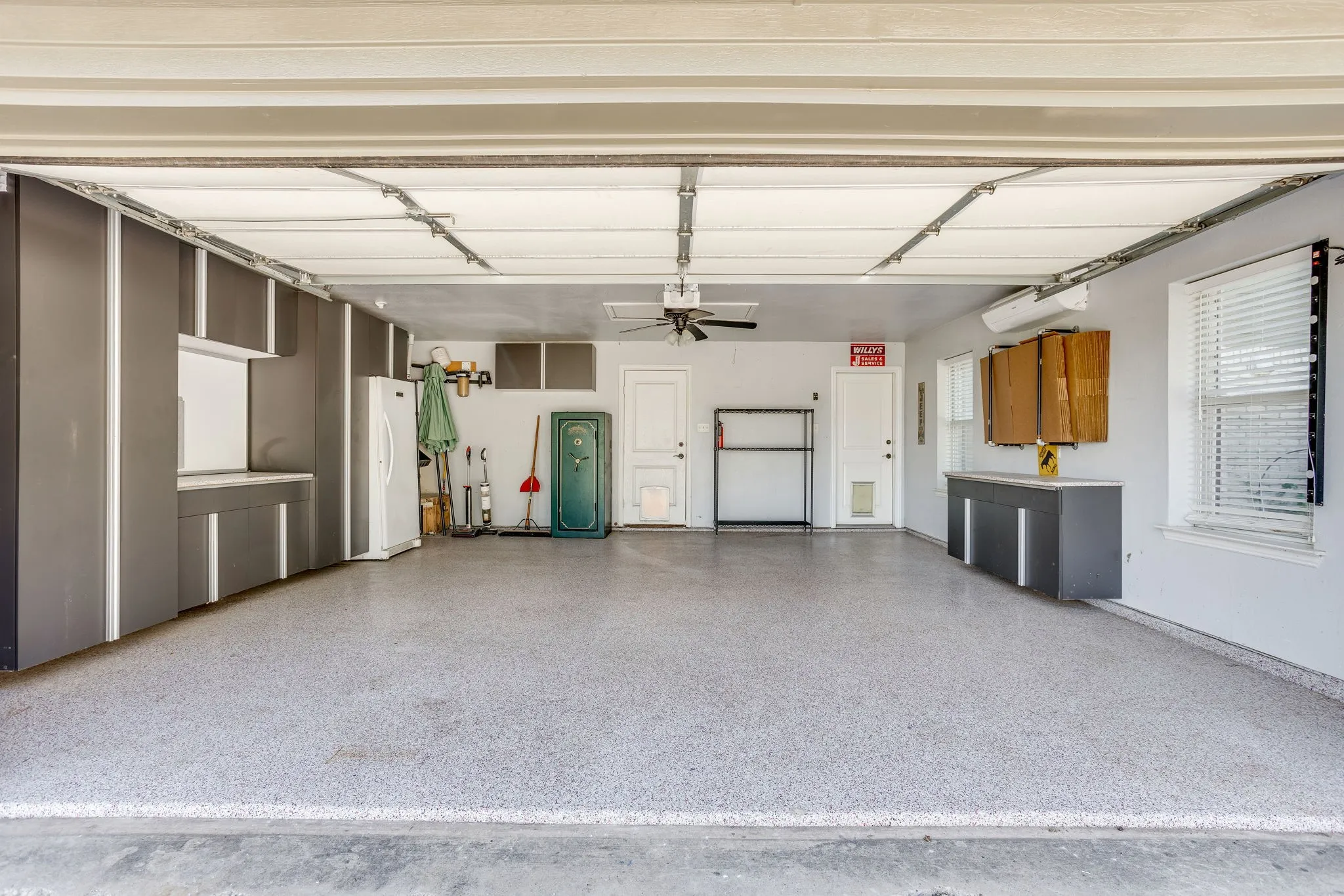 21x21 oversized garage with built in shelving, epoxy finished floor, mini-split with heat and air. There is also flat screen wiring below the mini-split and direct access to the patio and pool.