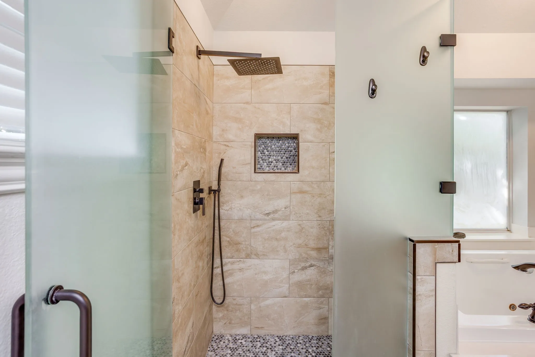 Shower has recently been remodeled with rain showerhead and wand