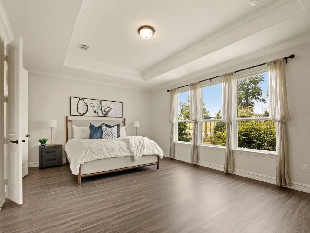 Primary with tray ceiling and great natural light