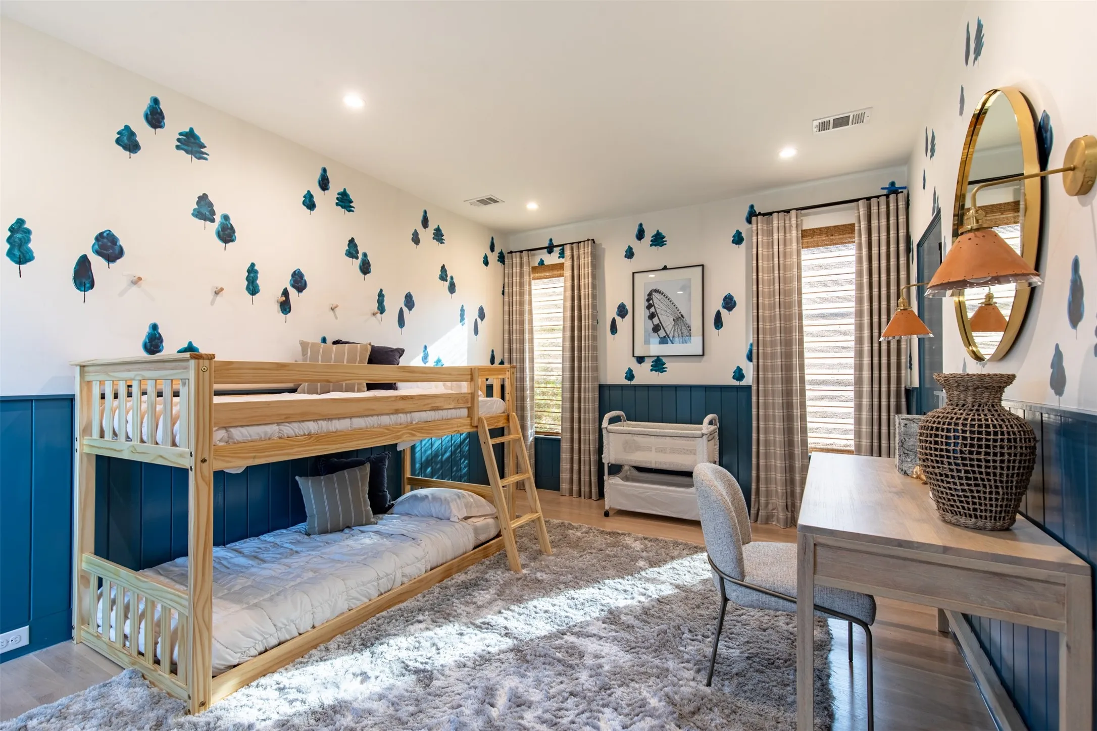Room featuring light wood-finish flooring, recessed lighting, and white walls with decorative blue accents