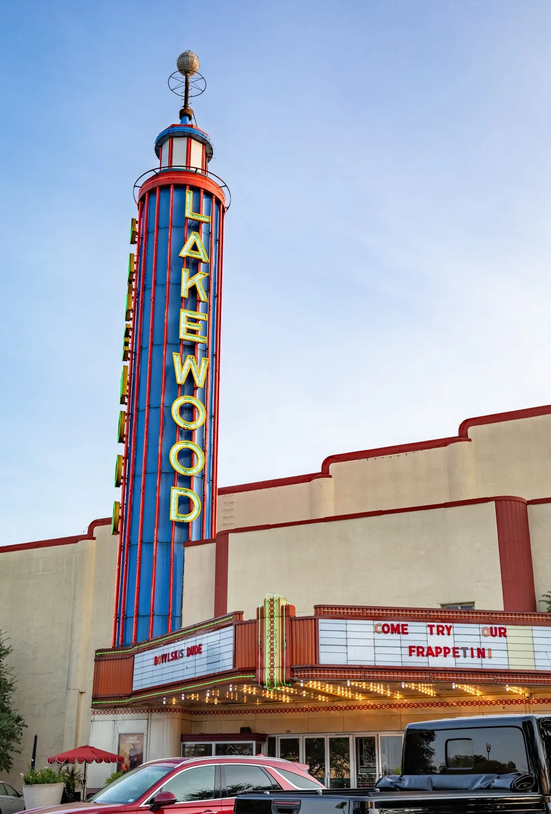 Historic theater facade featuring a prominent vertical sign with illuminated lettering