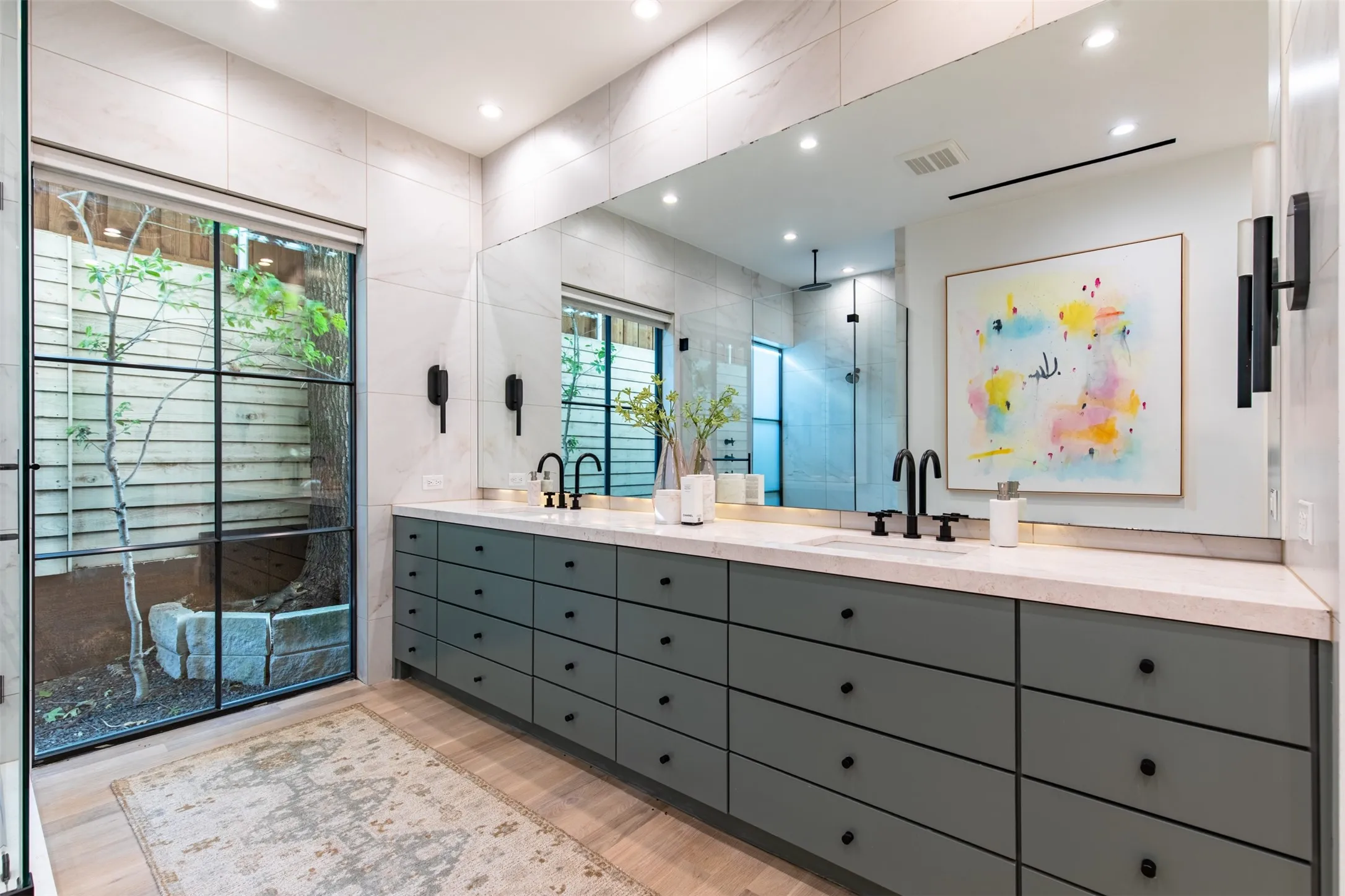 Dual vanity featuring a light-toned countertop and matte gray cabinetry