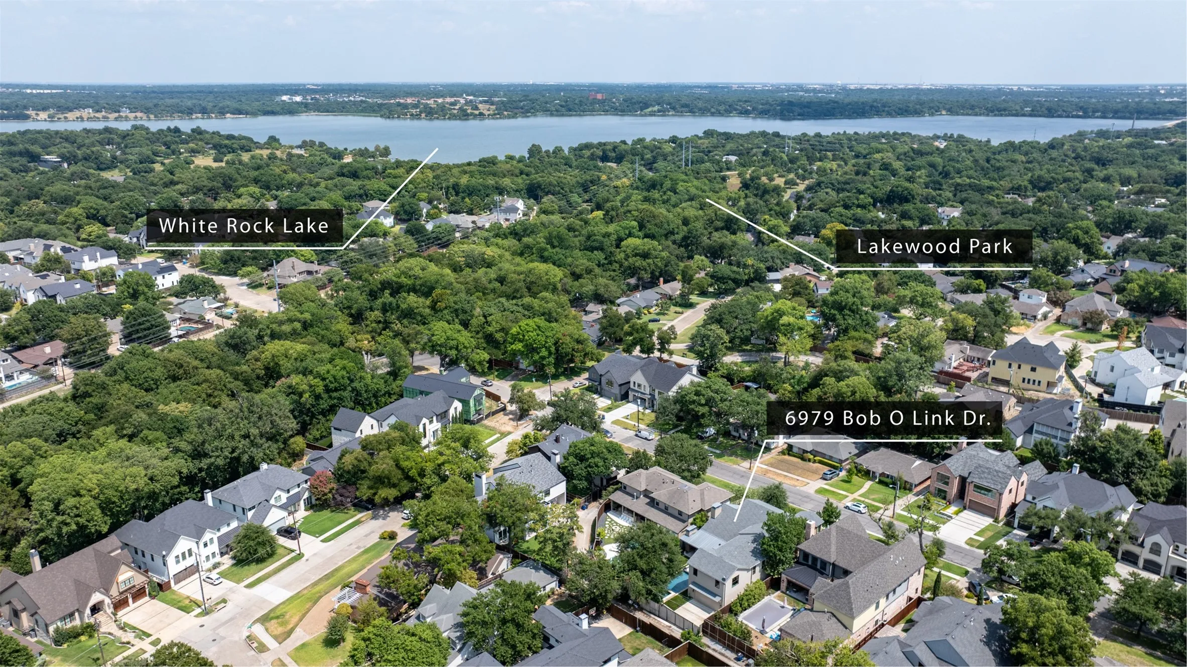 Aerial perspective showcasing a residential neighborhood with mature trees and varied architectural styles