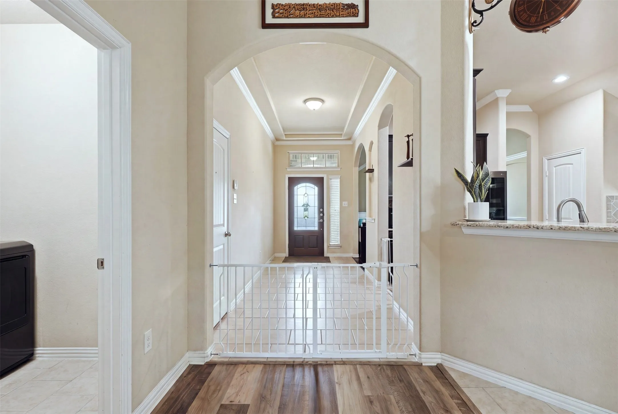Wood-finish flooring with a light-toned tile entry